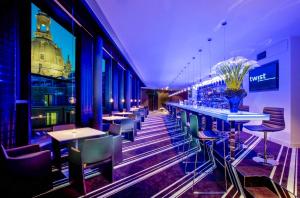 a bar with tables and chairs in a restaurant at INNSiDE by Meliá Dresden in Dresden +37 photos