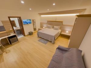 a large room with a bed and a television at Villa Paririö in Canoa Quebrada +121 photos