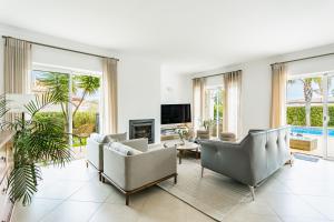 a living room with couches and a tv at Casa Eleonora lifestyle Lodge in Lagos