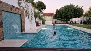 a person swimming in a swimming pool in a house at Paraíso Azul in Eira do Chão