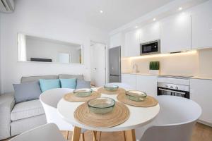 a living room with a white table with bowls on it at APARTAMENTOS CARMEN in Maro