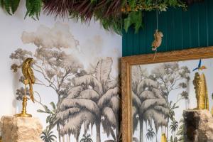 a wall with a painting of a mural of trees at Appartement jungle in Moulins +4 photos