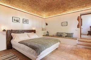 a bedroom with a bed and a brick ceiling at Agriturismo PANCOLINA in San Gimignano +13 photos