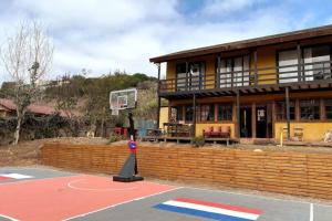 a basketball court in front of a building with a basketball hoop at Girasol Country House BBQ Parking & Shared Pool Wifi in Algarrobito