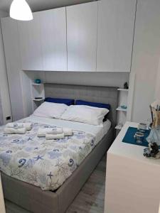 a bedroom with a bed with two towels on it at Antema in Scario