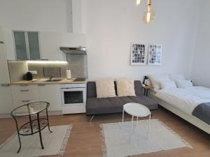 a living room with a couch and a table at CozyCentralApartment in Kecskemét