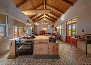 a kitchen with a stove top oven in a room at fijnbosch manor at romansbaai in Gansbaai +24 photos