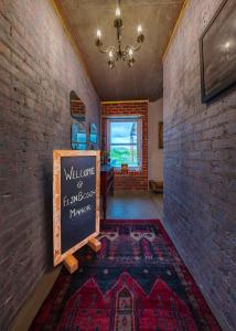 a room with a chalkboard in a brick wall at fijnbosch manor at romansbaai in Gansbaai