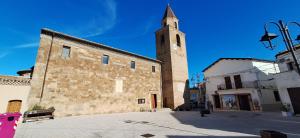 a building with a tower with a clock on it at Cottage in Campomarino old town in Campomarino