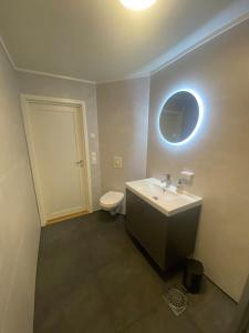 a bathroom with a sink and a toilet at Havblikk in Stø +29 photos