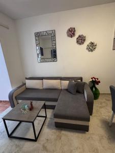 a living room with a couch and a table at Apartman Nonno Božo 1 in Fažana