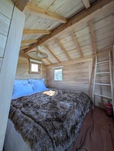 a bedroom with a bed in a log cabin at La ferme de Basseilles in Mozet  +38 photos