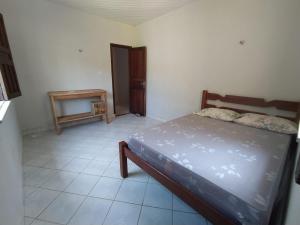 a small bedroom with a bed and a table at La Fortaleza Algodoal in Maracanã