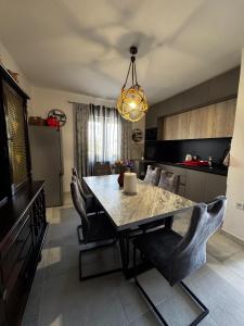 a kitchen with a dining room table and chairs at Apartman Nonno Božo 2 in Fažana
