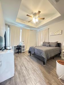 a bedroom with a bed and a ceiling fan at Premier Luxe Villa in Weslaco