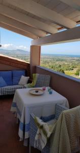 a table and chairs on a balcony with a view at Affaccio sul Golfo dell'Asinara in Badesi