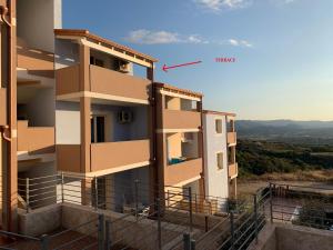a view of a building with a bird in the sky at Affaccio sul Golfo dell'Asinara in Badesi +3 photos