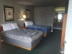 a hotel room with two beds and a window at King Bed Hotel Studio 102 in Livingston
