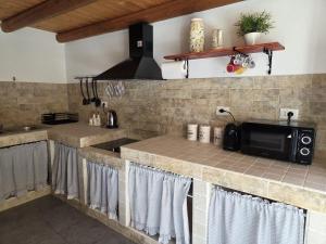 een keuken met een aanrecht met een magnetron bij Casa Whitaker in Palermo