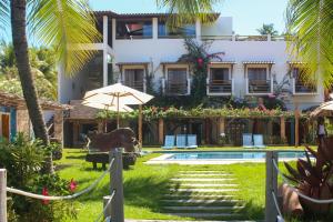 a resort with a pool and a building at Pousada Villa Bougainville Maragogi in Maragogi