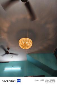 a chandelier hanging from the ceiling of a room at R & P Heritage Stay in Madurai