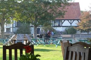a group of picnic tables and chairs in a park at The Dolphin Inn in Thorpeness