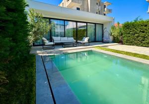 a swimming pool in the backyard of a house at White Beach Villa 2 - Luxury in Velipojë