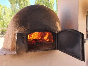 a brick oven with a fire in it at Celestino Posta Andina in Barreal