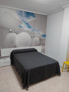 a bedroom with a bed and a painting on the wall at Hotel Cervantes in Mahora +45 photos