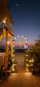 a view of a beach at night with a clock in a glass case at Mia's beach resort goa in Patnem