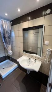 a bathroom with a sink and a mirror at Paleo Apartments in Paleokastritsa +24 photos