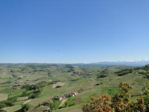 a view from the top of a hill with green fields at Di-vinodormire in La Morra