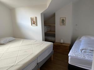 a bedroom with a white bed and a closet at AO Duplex 82 m2 in Vars