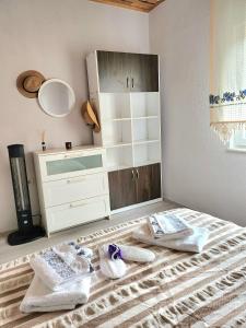 a bedroom with a dresser and shoes on a bed at Olympos Orange Village Nature, Sea and You in Kumluca