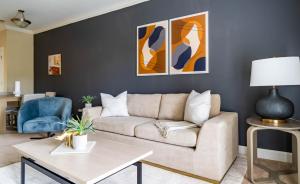 a living room with a couch and a table at The Greensboro II Vibe 8746 in Greensboro