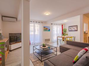 un soggiorno con un divano e una TV di Apartment Le Christina by Interhome a Sainte-Maxime