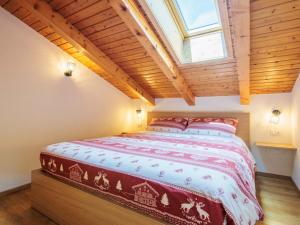 a bedroom with a large bed in a attic at Apartment Penia 2-3 by Interhome in Canazei