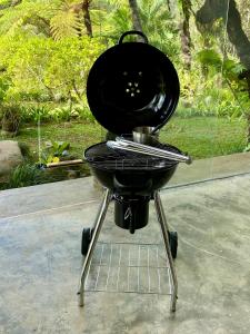 a black grill sitting on top of a table at Castle in the sky mountain bliss, Kintamani area in Plaga