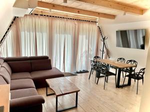 a living room with a couch and a table at Owczarzówka in Sękowa