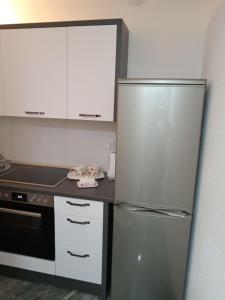 a kitchen with a stainless steel refrigerator and a stove at Sokak Apartman in Bihać +12 photos