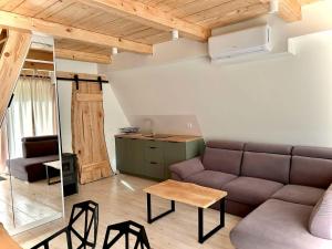 a living room with a couch and a table at Owczarzówka in Sękowa