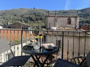 a table on a balcony with a view at Holiday Home La casa di Anna by Interhome in Dolcedo