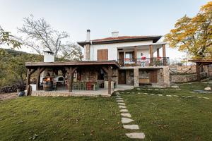 a large house with a porch and a patio at Вила Китна in Lozno