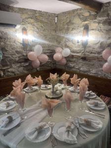 a table with pink balloons and glasses on it at Вила Китна in Lozno +19 photos