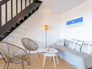 a living room with a couch and chairs and a table at Apartment Lou Gangui by Interhome in Carqueiranne +25 photos