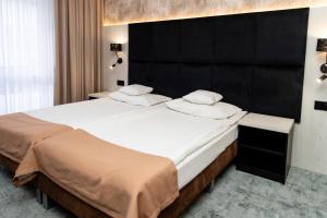 Łóżko lub łóżka w pokoju w obiekcie Hotel Aquarius Restaurant Wellness Spa