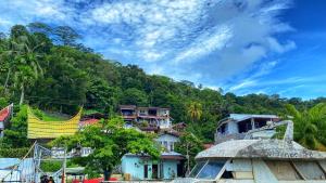 a group of houses in front of a mountain at Evergreen Lodge in Padang