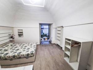 a bedroom with a bed and shelves in it at Apartment Il Balconcino di Sorrento by Interhome in Sorrento