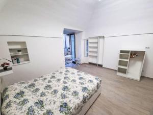 a bedroom with a bed with a floral bedspread at Apartment Il Balconcino di Sorrento by Interhome in Sorrento