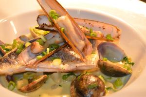 a plate of food with fish and clams on a plate at The Dolphin Inn in Thorpeness